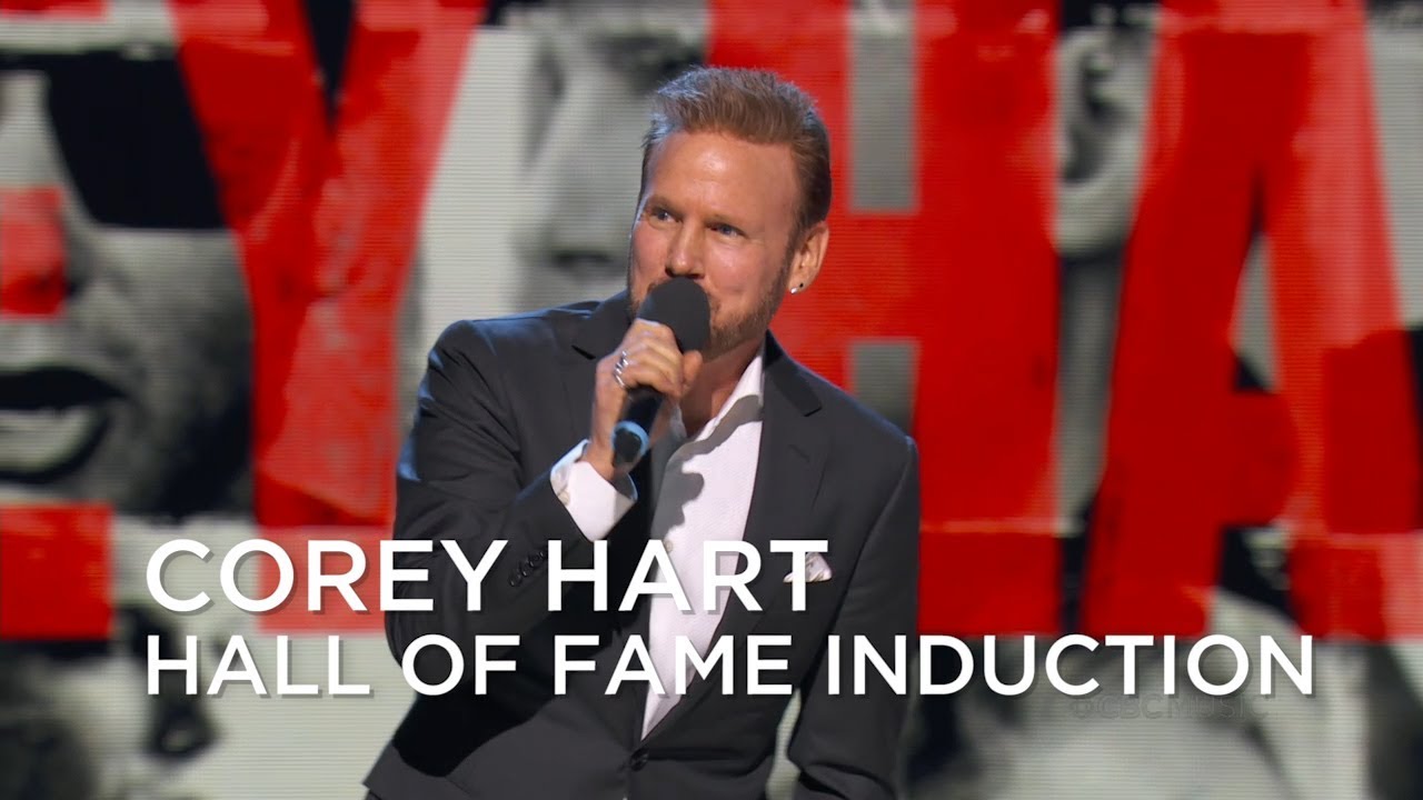 Corey Hart holding a microphone at an award ceremony